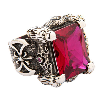 A close-up of the silver dragon talon ring, detailing the four powerful claws gripping the large rectangular red stone.