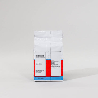 Back view of a single package of Saf Instant yeast on a grey background
