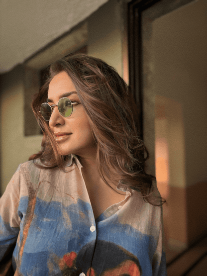 Close view of a woman in tinted glasses wearing the Shakuntala shirt, looking to the side