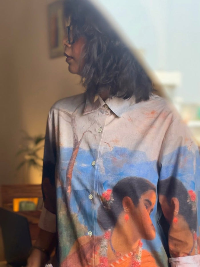 Close view of the Shakuntala shirt front on a woman, with the painted woman's face and orange sari
