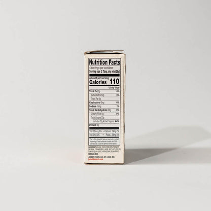 Side view of a single pack of junket simply strawberry ice cream mix on a grey background