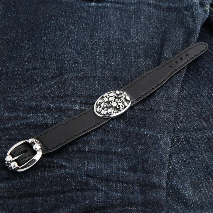 The full length of the black leather skull bracelet, showing the skull stack plate and the silver skull buckle.