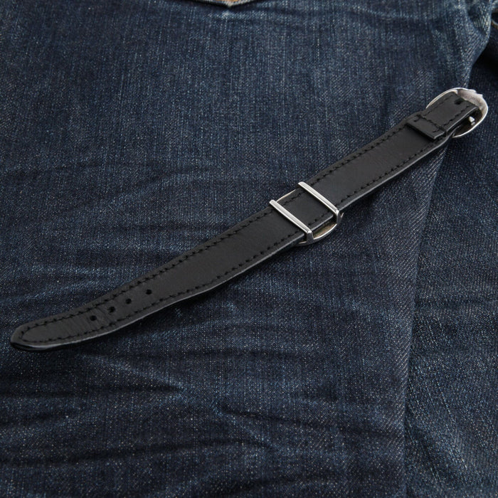 Underside of the black leather strap with its silver buckle, two keepers and the row of adjustment holes.