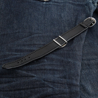 Underside of the black leather strap with its silver buckle, two keepers and the row of adjustment holes.