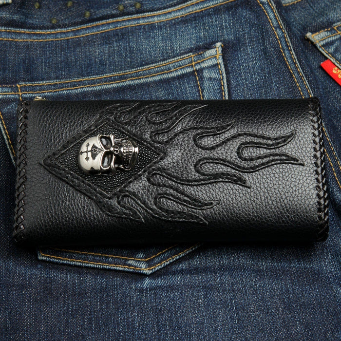 Cross-etched metal skull centered on the genuine stingray diamond panel, leather flames sweeping across the black cover