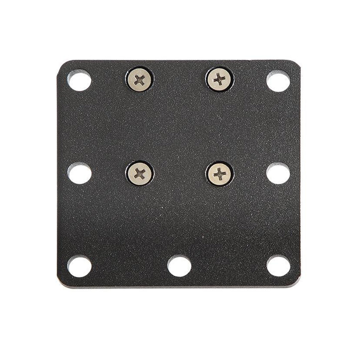 The Square AMPS Mounting Plate is a black, square metal plate with rounded corners, eight holes (four at the corners), and four screws installed in a VESA 75 pattern near the center.
