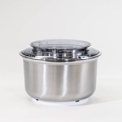 A stainless steel bowl with a clear lid, placed on a white base.