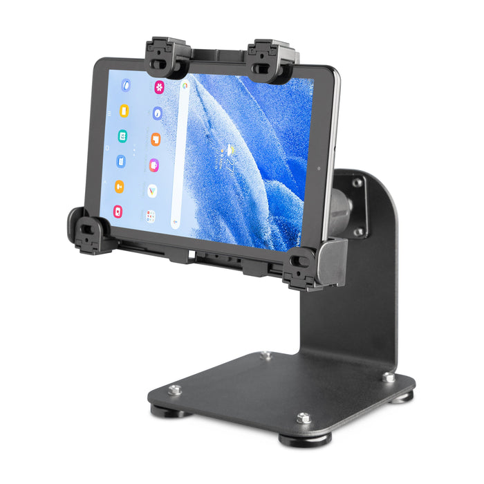 The SteadyMag™ Magnetic Mount System with LockVise™ Locking Tablet Holder securely holds a tablet in landscape mode, featuring a sturdy base, padded corner grips for protection, and displaying colorful app icons on a blue abstract wallpaper.
