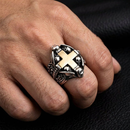 Man wearing sterling silver Gothic skull cross ring with gold accent on index finger