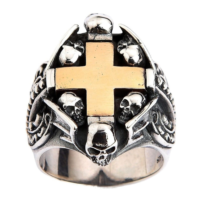 Top view of sterling silver Gothic ring featuring yellow gold cross surrounded by seven skulls