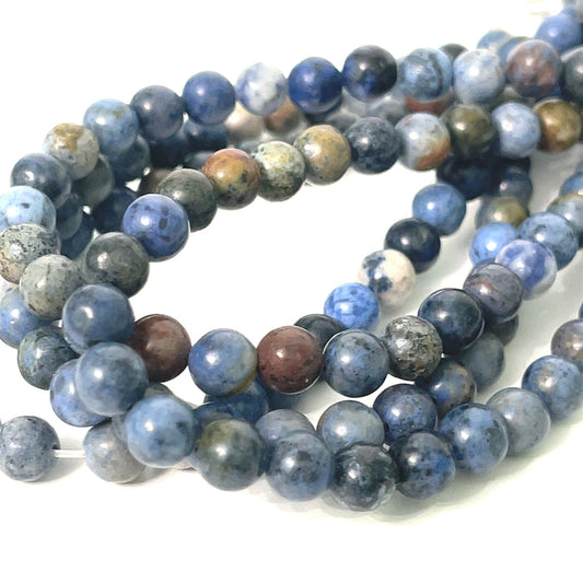 6mm Dumortierite smooth round gemstone strand, on a white background, front overview.