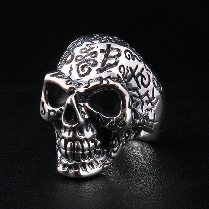 Handcrafted gothic skull ring with tattoo style symbols in solid silver