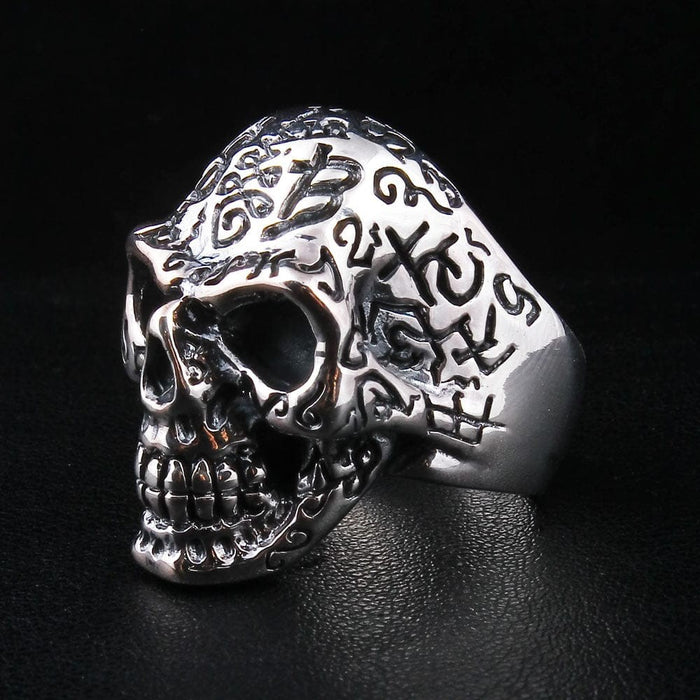 Men's sterling silver skull ring featuring intricate tattoo engravings and numbers
