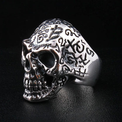 Men's sterling silver skull ring featuring intricate tattoo engravings and numbers