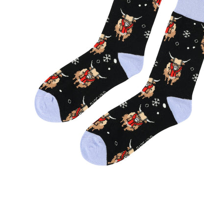 flat lay of christmas highland cows bamboo socks
