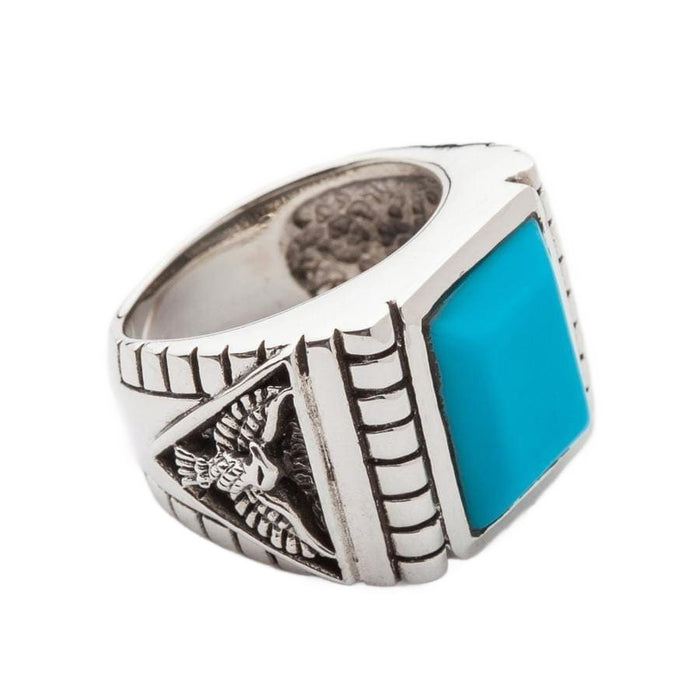 A man's sterling silver eagle ring with a turquoise stone, embodying a bold Southwestern jewelry style.