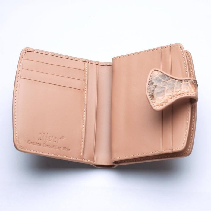 Open interior of old rose crocodile wallet revealing smooth leather card slots, bill compartment, and River Genuine Crocodilian Skin embossed branding