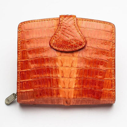Front view of a two-tone orange crocodile leather women's wallet with snap tab closure and side zipper pull