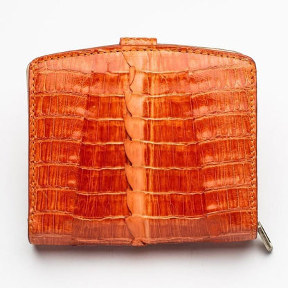 Back view showcasing the raised hornback spine running down the center of the two-tone orange crocodile leather wallet