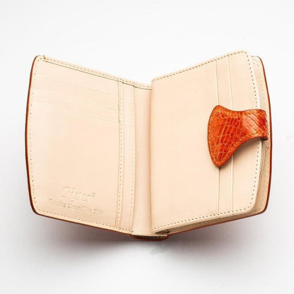 Inside view of cream leather card slot compartments with orange crocodile skin snap tab on the handcrafted women's wallet