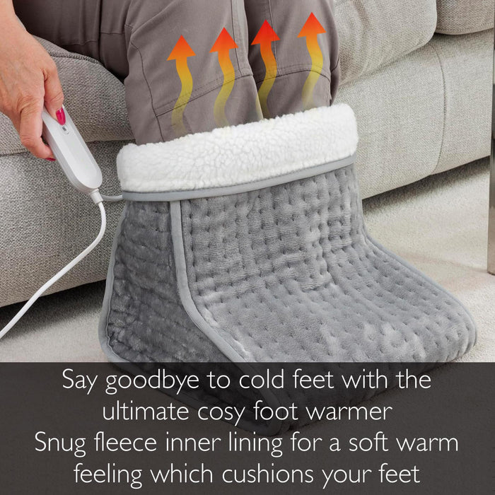Gray foot warmer with fleece lining being used by a person on a couch. - Buy Now Grey Luxury Heated Throw + Foot Warmer