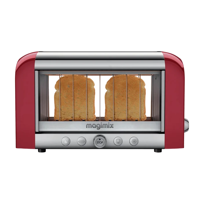 A red Magimix toaster with transparent glass side windows showing toasting bread, featuring stainless steel and borosilicate glass construction with control buttons on the front.