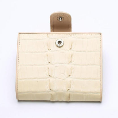 Front view of a genuine white pearl crocodile leather wallet for women, featuring a classic snap button closure and unique scale texture.