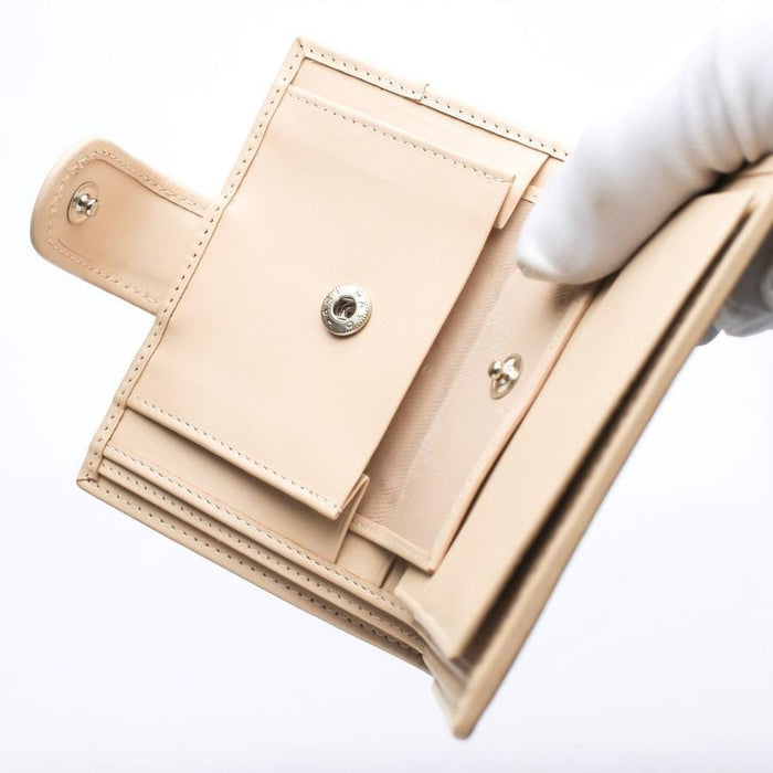 Detail of the secure snap button closure and coin pocket on the ladies' leather wallet.