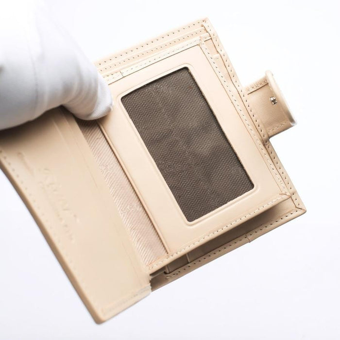 Interior layout of a ladies' white leather wallet featuring a clear ID window slot and credit card compartments.