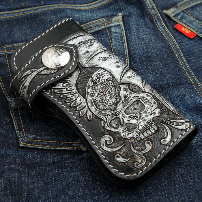 An angled view of the gothic skull wallet, highlighting the hand-carved leather texture.
