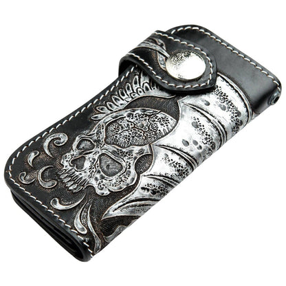 The hand-carved leather biker wallet folded, showing the snap closure and winged skull detail.