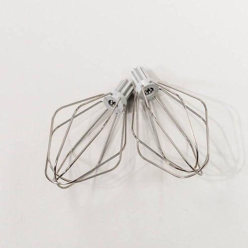 NutriMill wire whips on a grey background