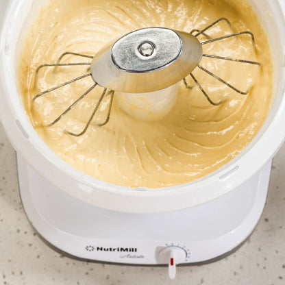 NutriMill artiste using wire whips and a metal whip driver to mix yellow batter