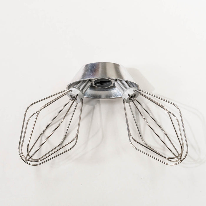 NutriMill wire whips attached to a metal whip driver on a grey background