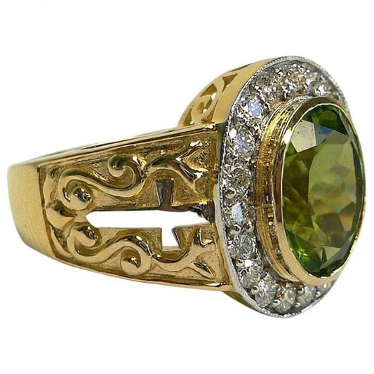 Yellow gold bishop ring with oval natural peridot center stone surrounded by sparkling CZ halo and ornate filigree scrollwork band