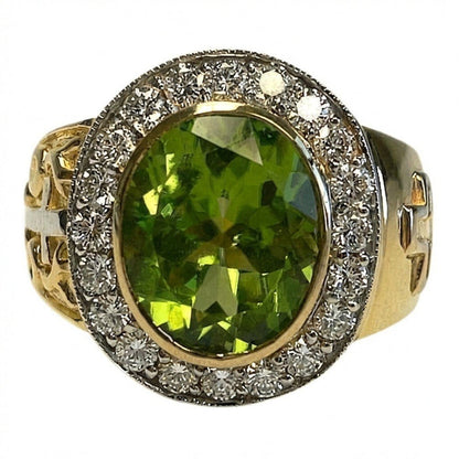 Top-down close-up of oval natural peridot gemstone encircled by diamond-style CZ halo in yellow gold bezel setting