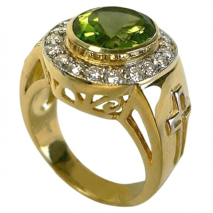 Three-quarter view of bezel-set oval peridot with CZ halo, cross motif and scrollwork cutouts on yellow gold bishop ring band