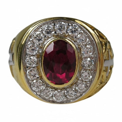 Close-up shot of the oval red ruby stone set in the yellow gold bishop ring.